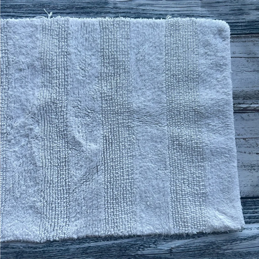 DKNY white bathroom rug 33in x 19in EUC